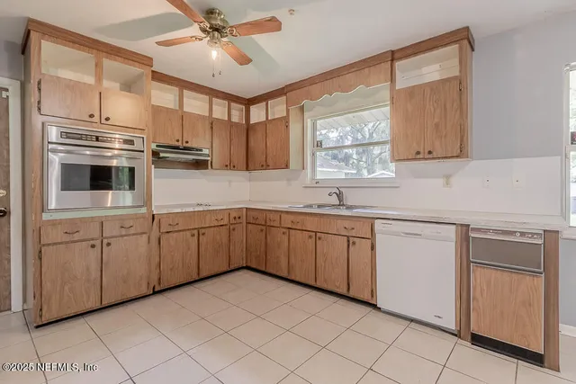 a kitchen with cabinets and window