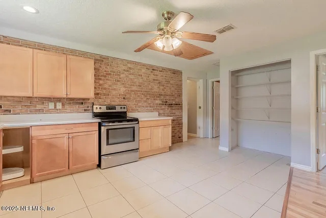 a kitchen with stainless steel appliances granite countertop a stove and a refrigerator
