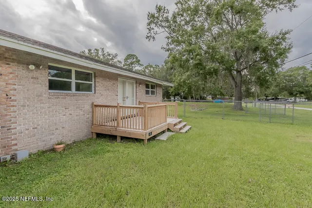 a view of a house with a backyard and a garden