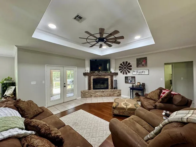 a view of a dining room with furniture and chandelier