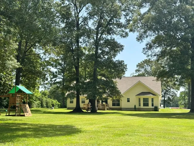 a front view of house with yard and green space