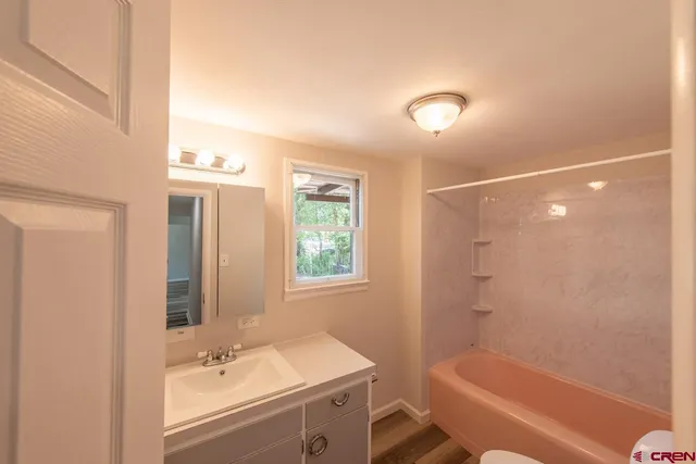 a bathroom with a sink a vanity and a window