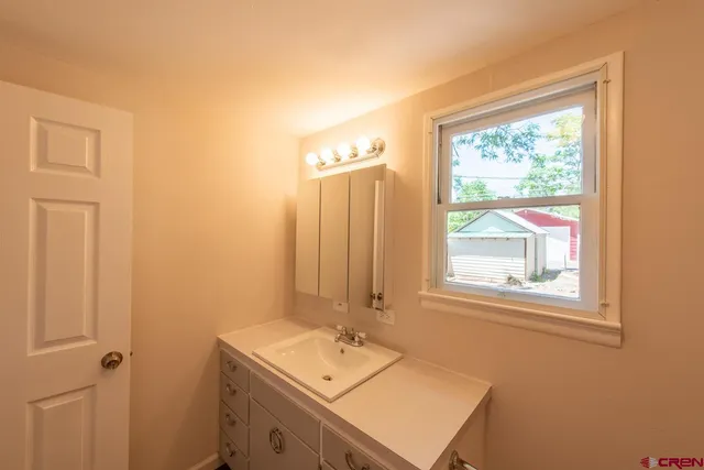 a view of a hallway with wooden floor and closet