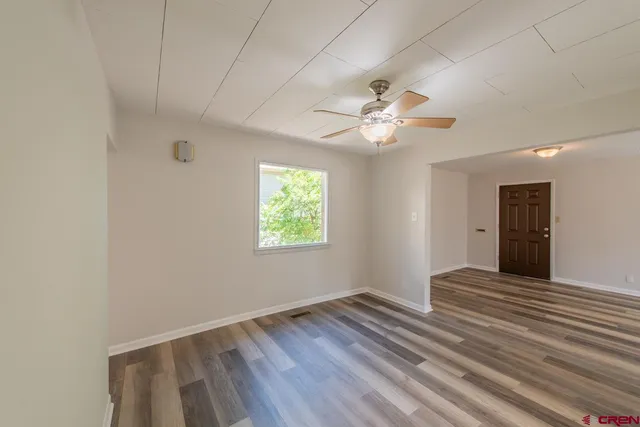 a view of a house with a small deck and a garden