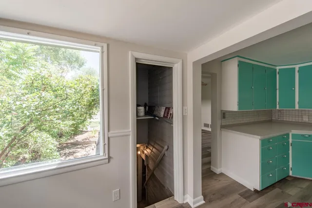 a view of a kitchen cabinets and a window