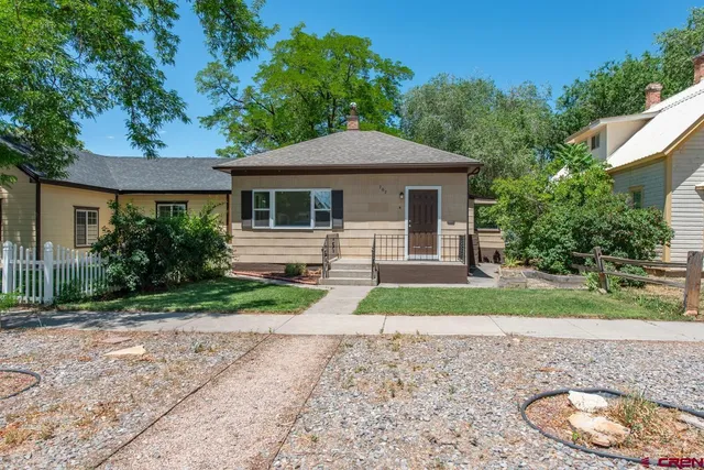 a front view of house with yard and green space