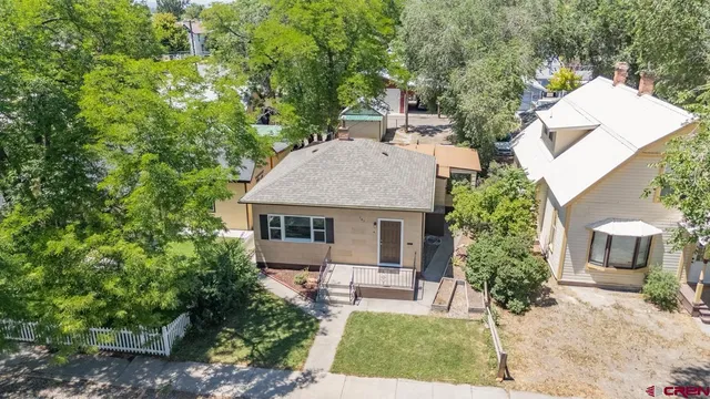 an aerial view of a house with garden space and street view