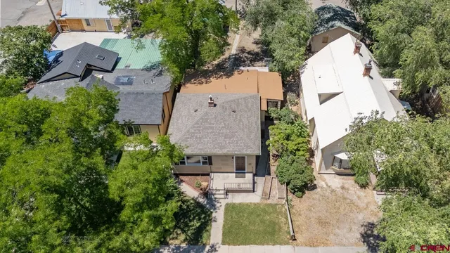 a front view of a house with a garden and plants