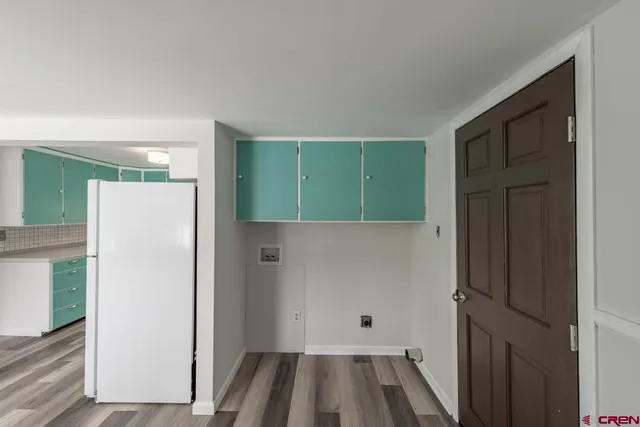a kitchen with kitchen island a sink a refrigerator and a stove top oven