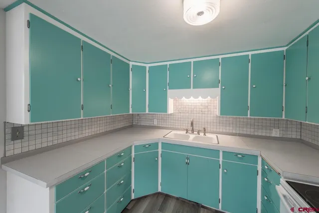 a kitchen with a refrigerator and white cabinets