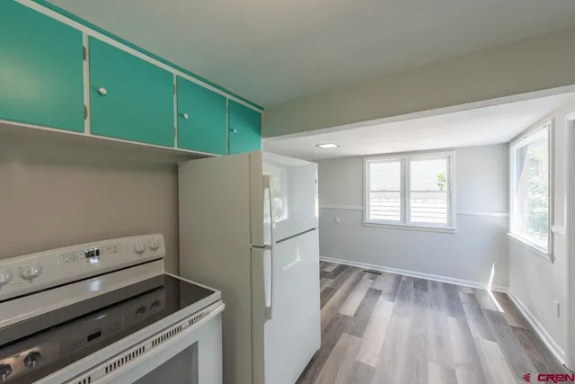 a kitchen with a refrigerator and a stove