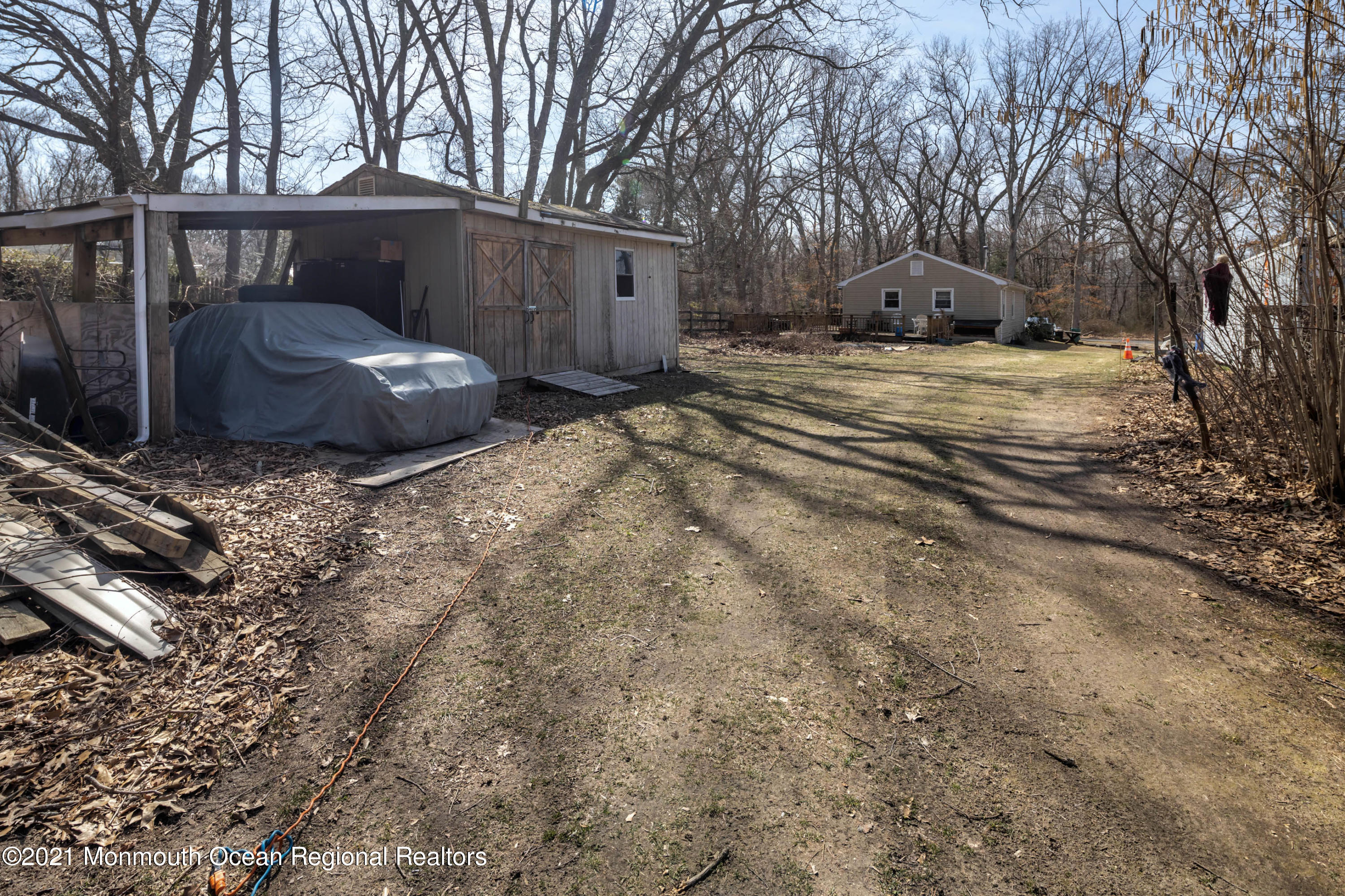 77 Maxim Road Howell, NJ 07731 - Photo 5 of 5 a backyard of a house with barbeque oven and trees