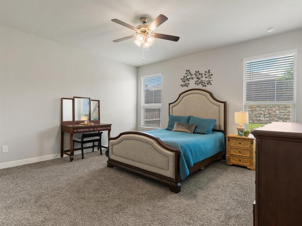 270 Lunayena Road Rhome, TX 76078 - Photo 26 of 37 The spacious primary bedroom offers a comfortable retreat with ample natural light and a well-proportioned layout, providing a private space to unwind at the end of the day.
