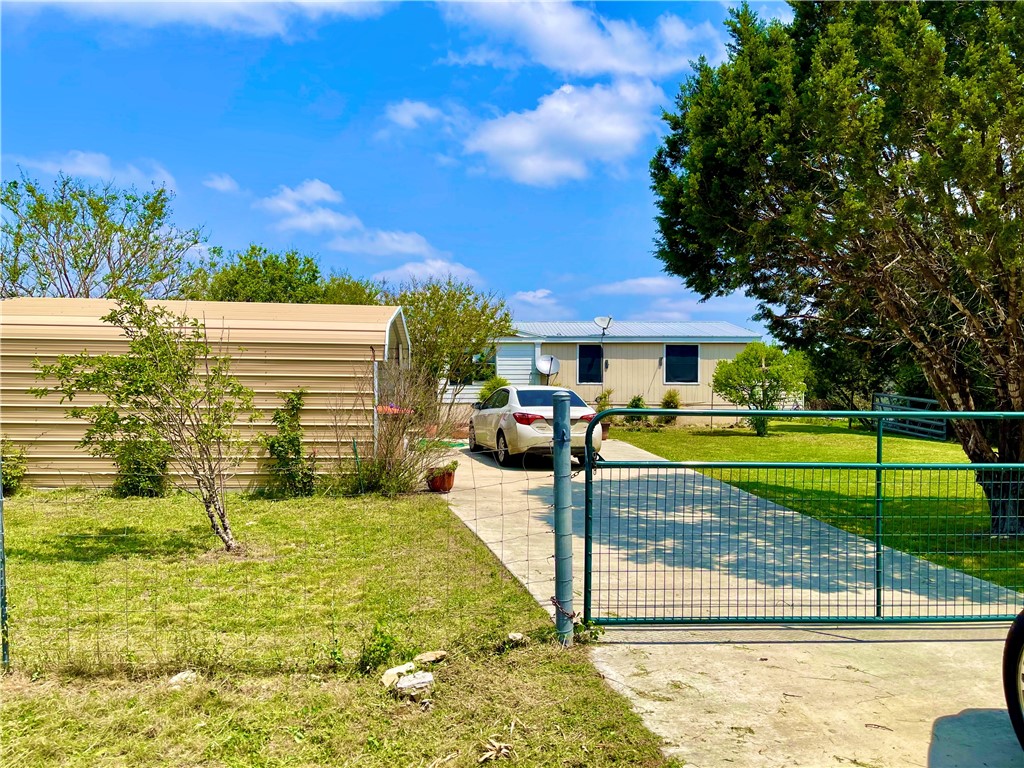 675 Rust Ranch Road Blanco, TX 78606 - Photo 1 of 1 a view of swimming pool with lawn chairs and plants