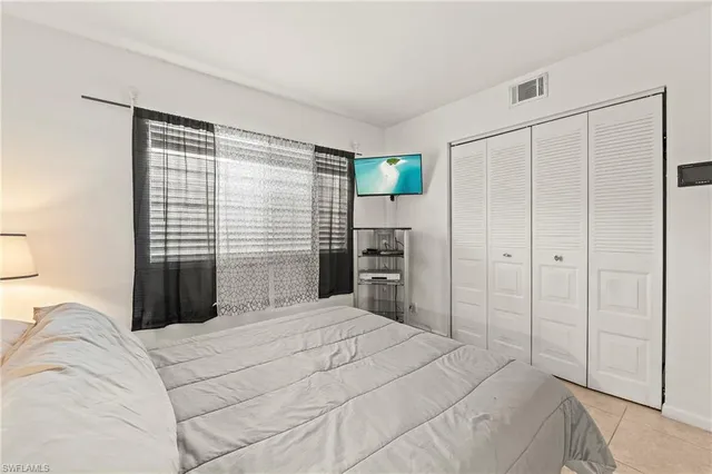 a bedroom with a bed and a closet