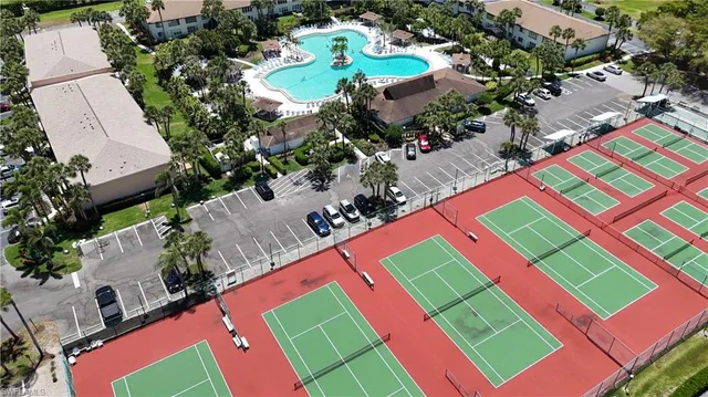 an aerial view of a tennis ground with large trees