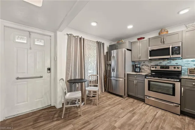 a kitchen with stainless steel appliances a stove a refrigerator and a microwave