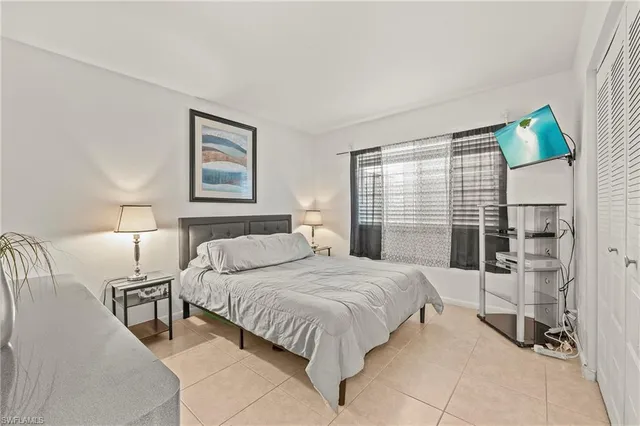 a bedroom with a bed and a lamp