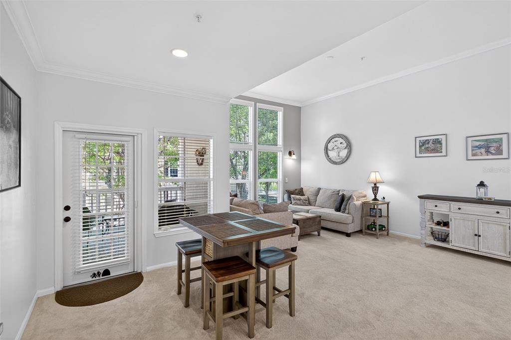 512 Water Street, Unit 512 Celebration, FL 34747 - Photo 11 of 46 a living room with furniture a window and a table