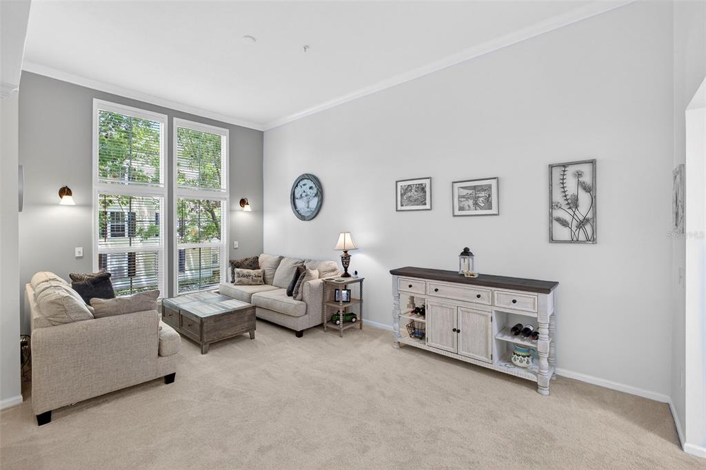 512 Water Street, Unit 512 Celebration, FL 34747 - Photo 12 of 46 a living room with furniture and a large window