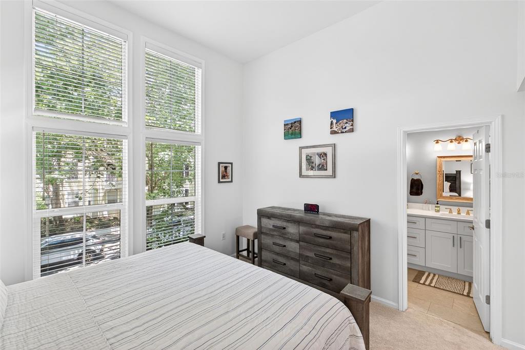 512 Water Street, Unit 512 Celebration, FL 34747 - Photo 14 of 46 a bedroom with a bed and a large window