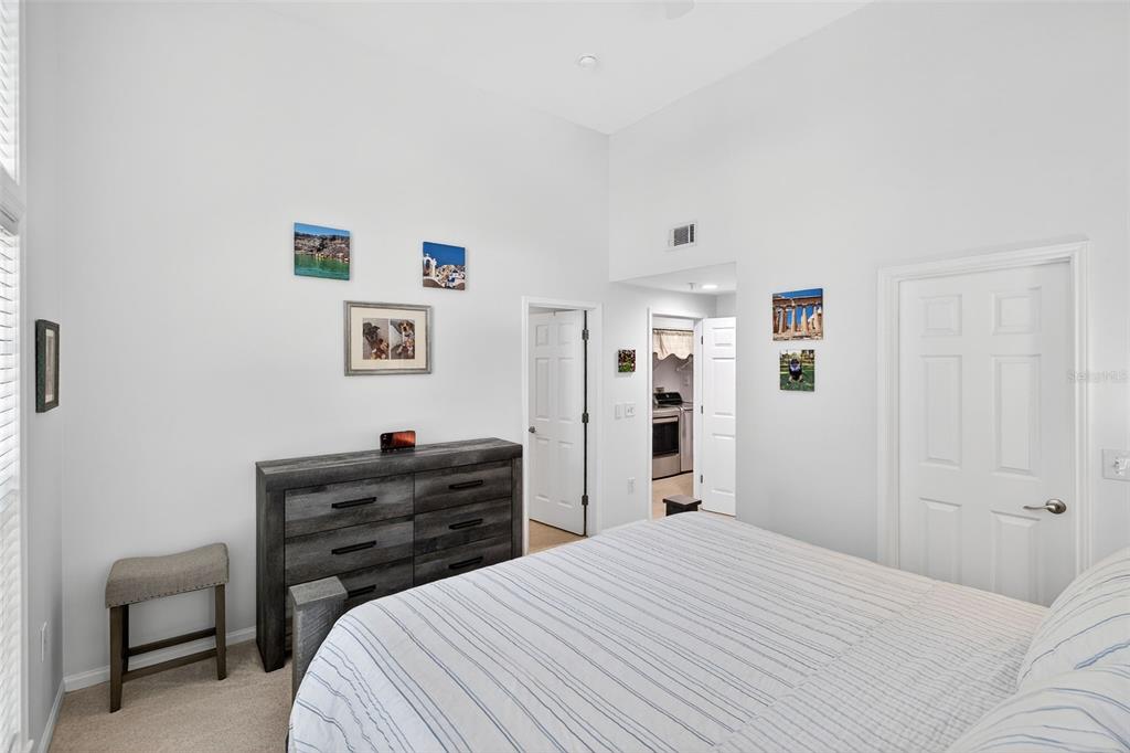 512 Water Street, Unit 512 Celebration, FL 34747 - Photo 16 of 46 a bedroom with a bed and a dresser