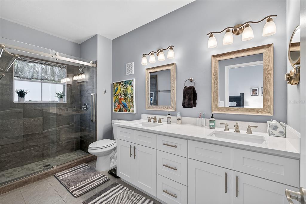 512 Water Street, Unit 512 Celebration, FL 34747 - Photo 17 of 46 a bathroom with a double vanity sink mirror and toilet