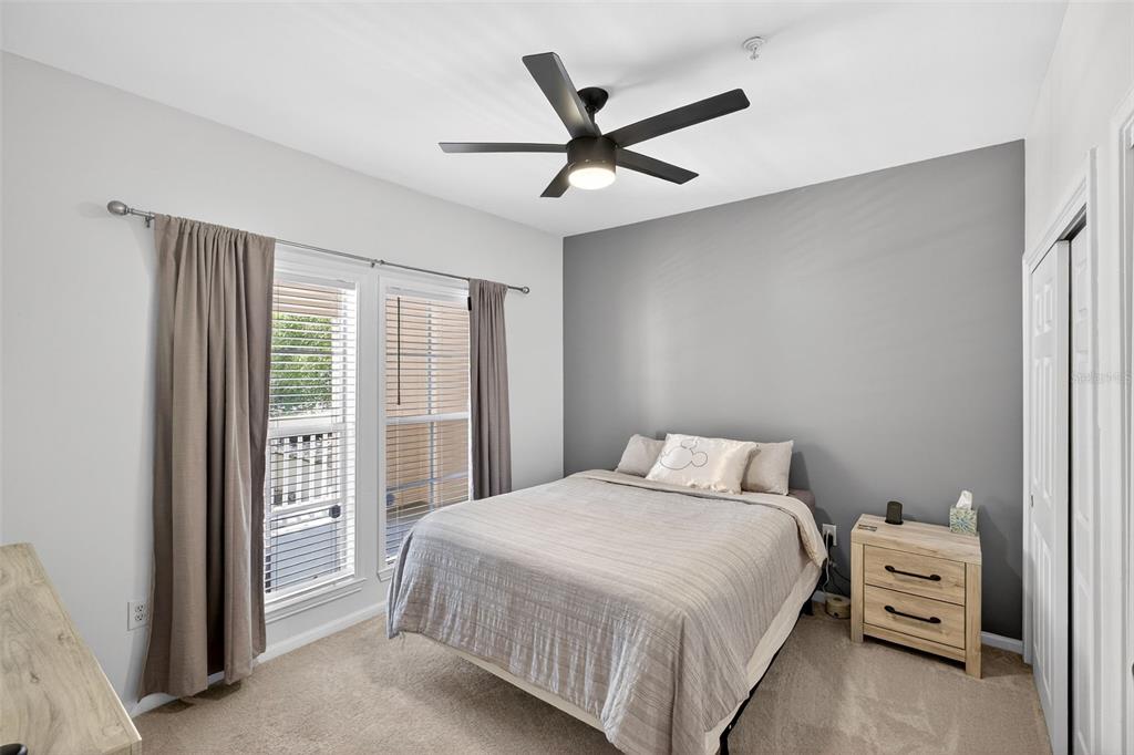 512 Water Street, Unit 512 Celebration, FL 34747 - Photo 18 of 46 a bedroom with a bed and a ceiling fan
