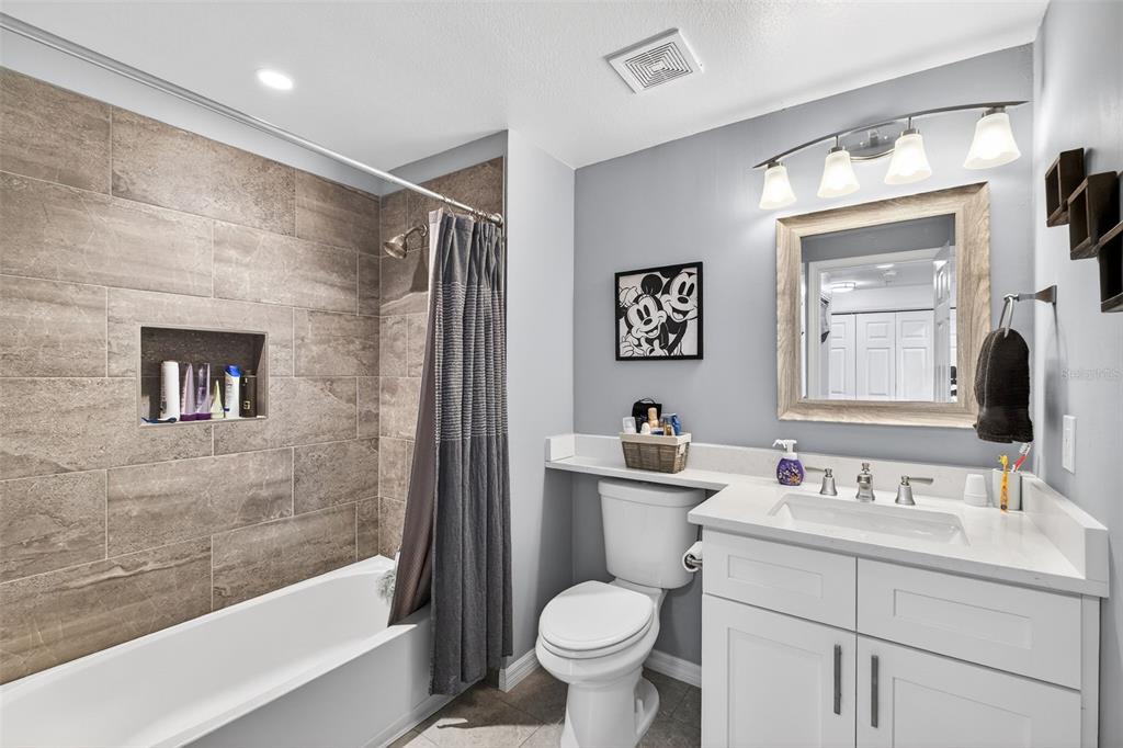 512 Water Street, Unit 512 Celebration, FL 34747 - Photo 19 of 46 a bathroom with a toilet sink and a mirror