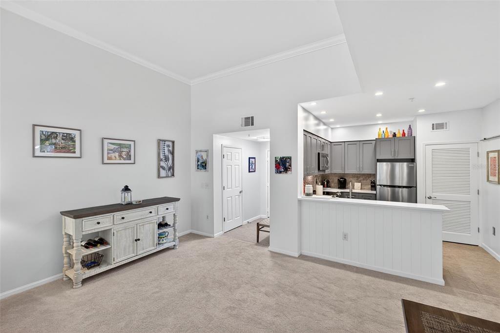 512 Water Street, Unit 512 Celebration, FL 34747 - Photo 2 of 46 a large white kitchen with stainless steel appliances granite countertop a stove and a refrigerator