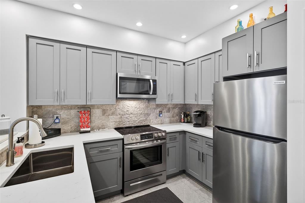 512 Water Street, Unit 512 Celebration, FL 34747 - Photo 3 of 46 a kitchen with cabinets stainless steel appliances and a sink