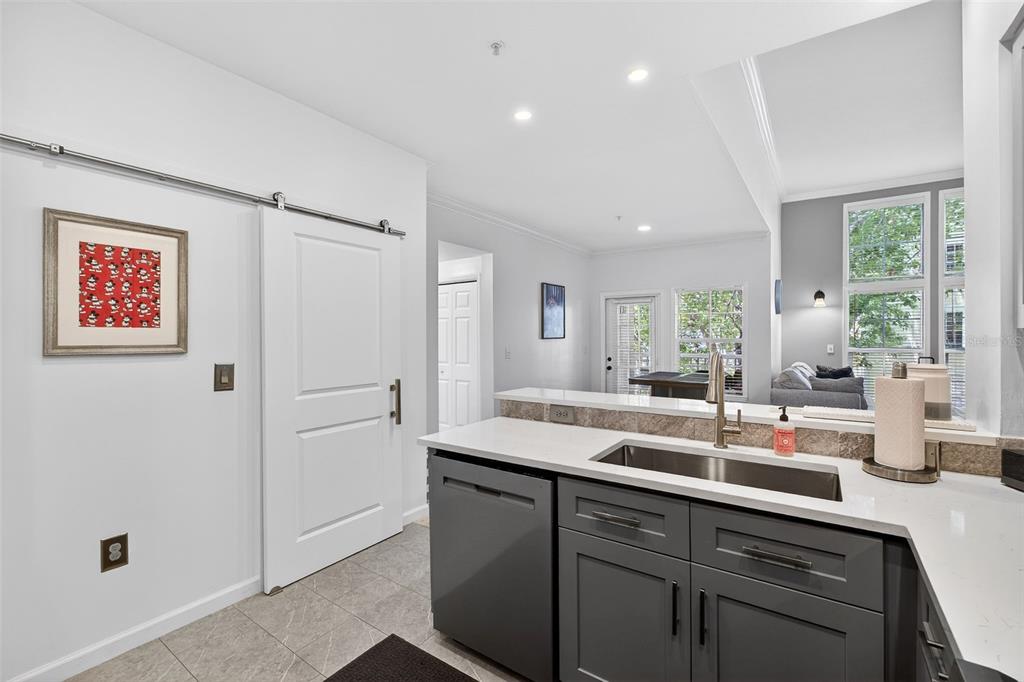 512 Water Street, Unit 512 Celebration, FL 34747 - Photo 5 of 46 a kitchen with a sink and a refrigerator