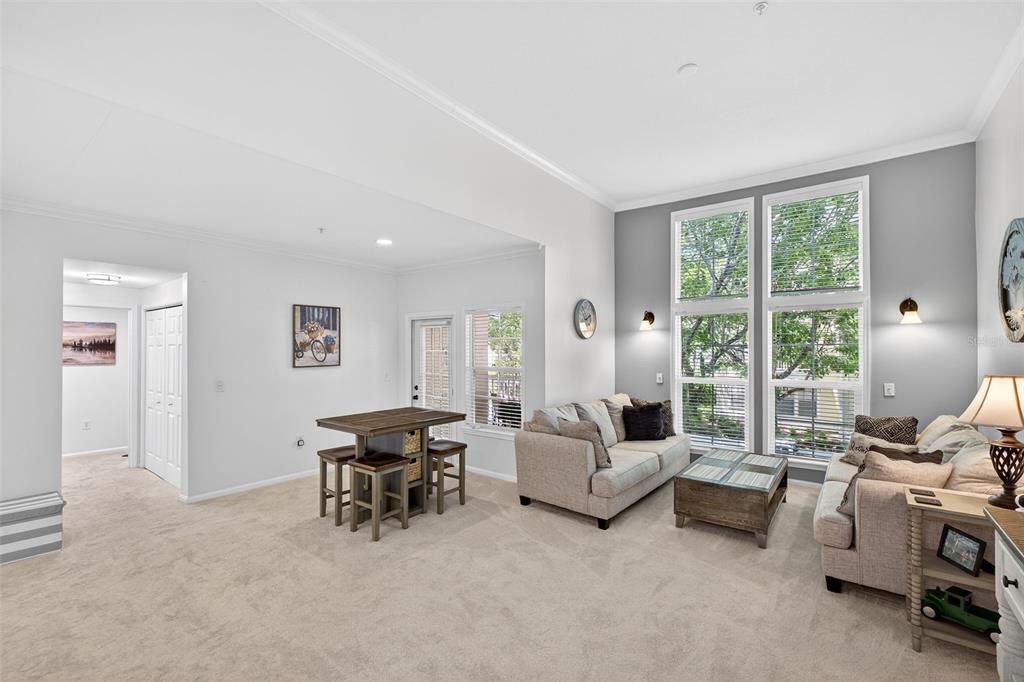 512 Water Street, Unit 512 Celebration, FL 34747 - Photo 6 of 46 a living room with furniture and large windows