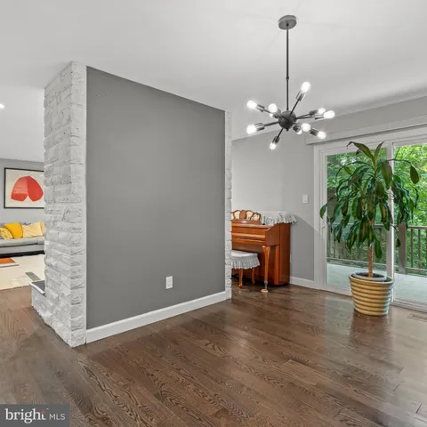 a dining room with furniture and a chandelier