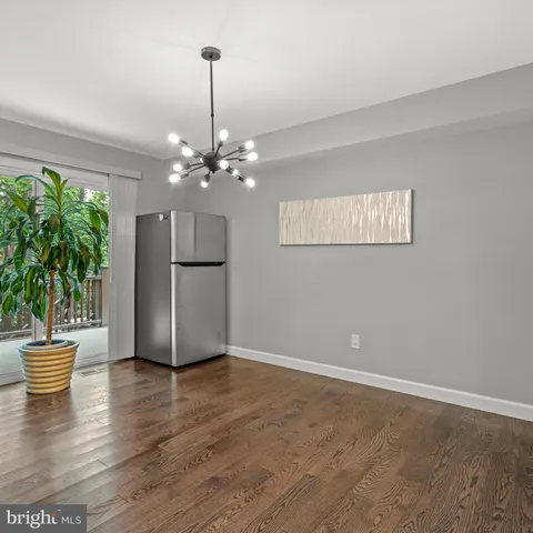a view of a kitchen with a refrigerator and a potted plant