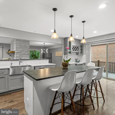 a kitchen with a table chairs sink and cabinets