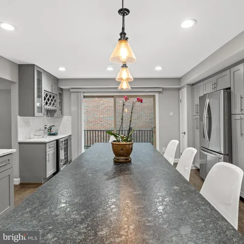 a large white kitchen with a large window