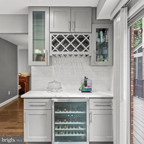a kitchen with stainless steel appliances kitchen island granite countertop a sink a stove and a wooden floors