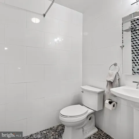 a bedroom with a bed chair and a window