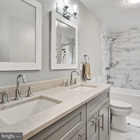 a close view of two sink and a mirror