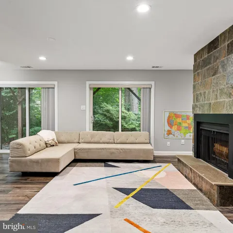 a living room with furniture and large windows
