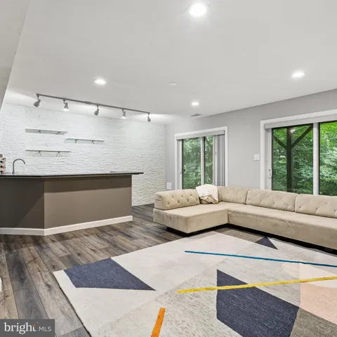 a view of an empty room with a fireplace and a window