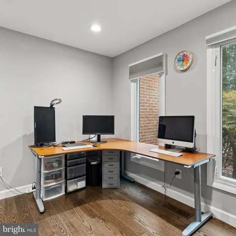 a view of a workspace with furniture and a window