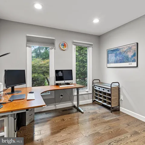 a view of a workspace with furniture and a window