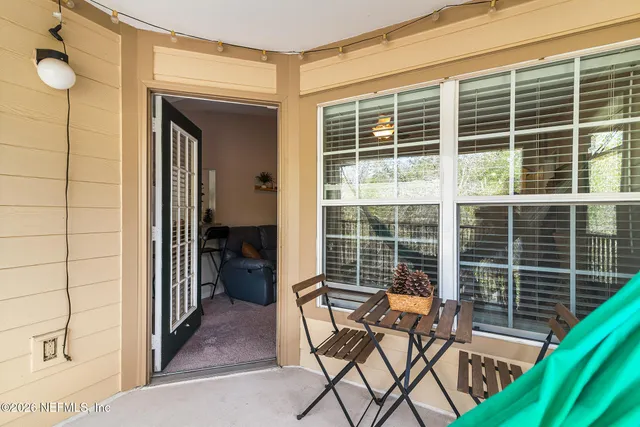 a view of a chair and table in the balcony