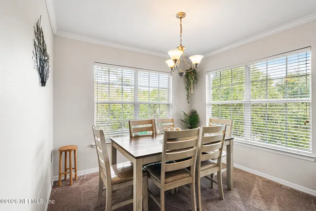 a view of a dining room with furniture window and outside view