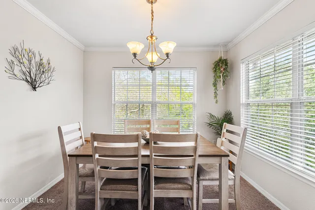 a view of a dining room with furniture window and outside view