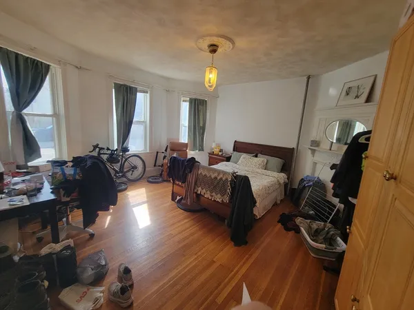 a bed room with a bed window and a mirror