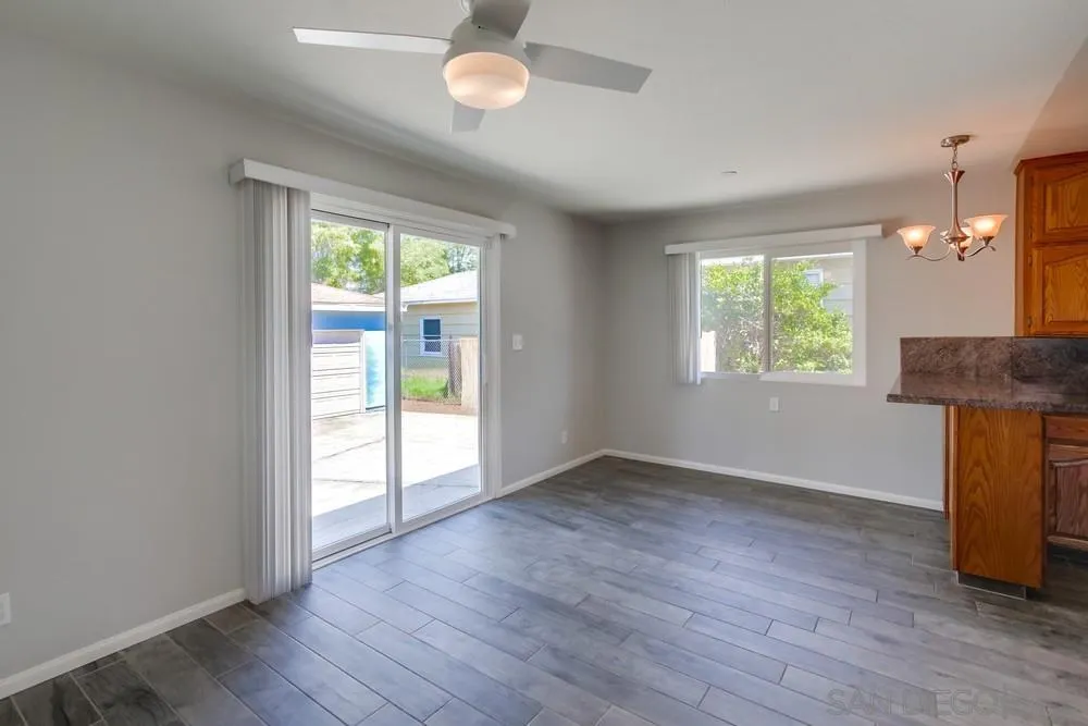7568 Ohio Place La Mesa, CA 91942 - Photo 12 of 32 an empty room with wooden floor and windows