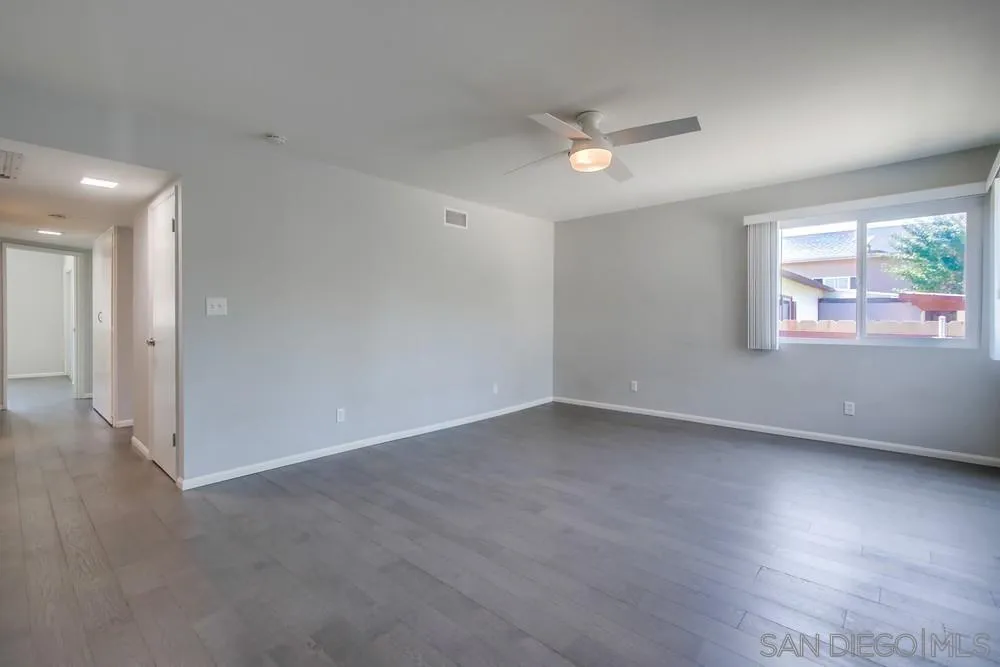 7568 Ohio Place La Mesa, CA 91942 - Photo 14 of 32 an empty room with wooden floor and windows